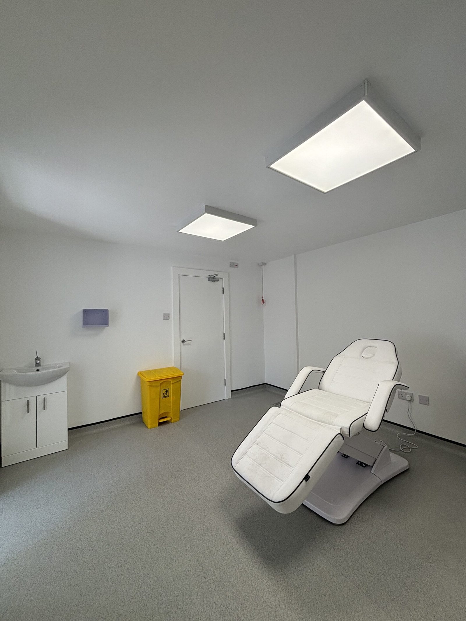 Bright, modern treatment room in the Wirral with adjustable bed 