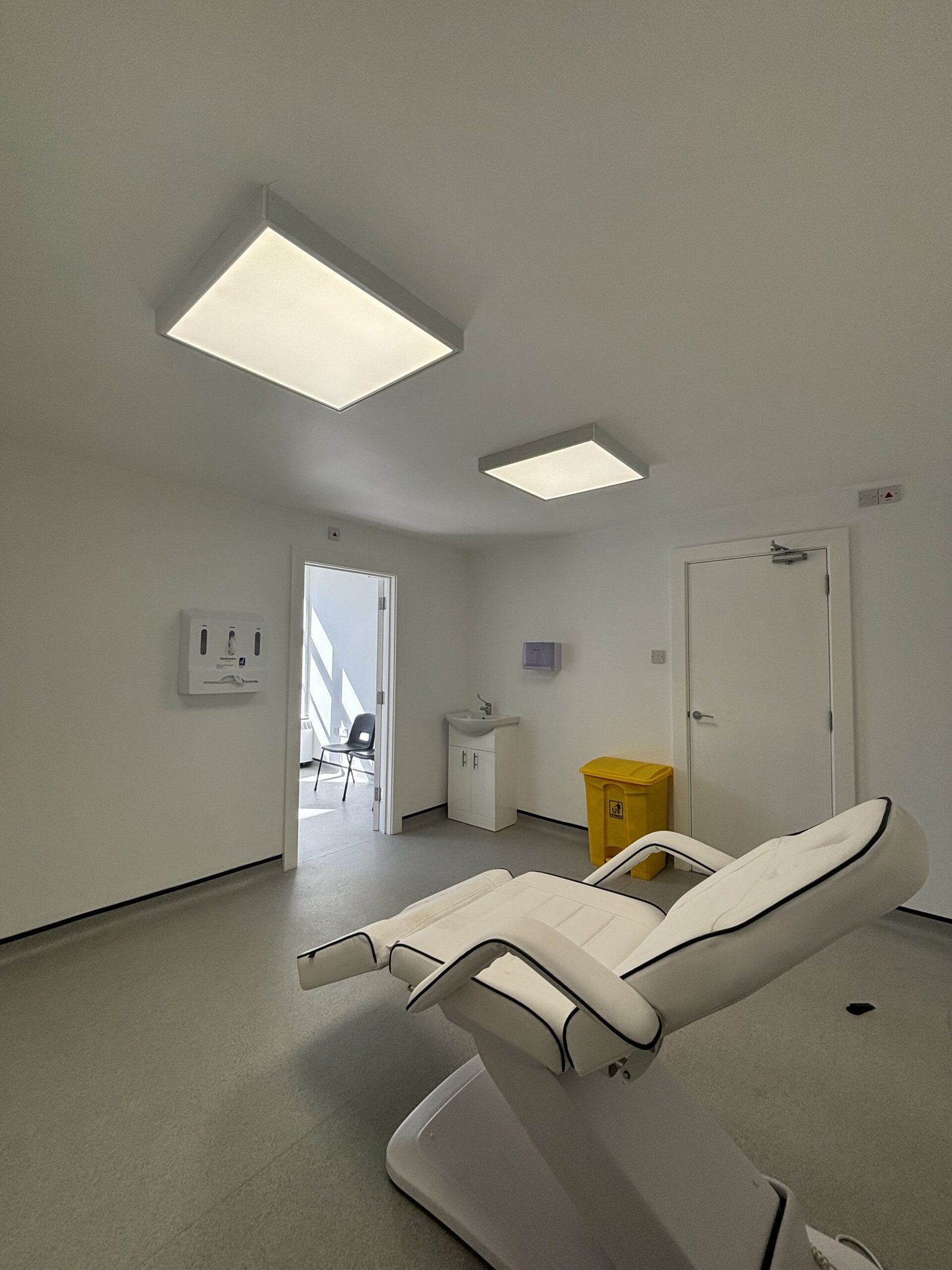 Bright, modern treatment room in the Wirral with adjustable bed 