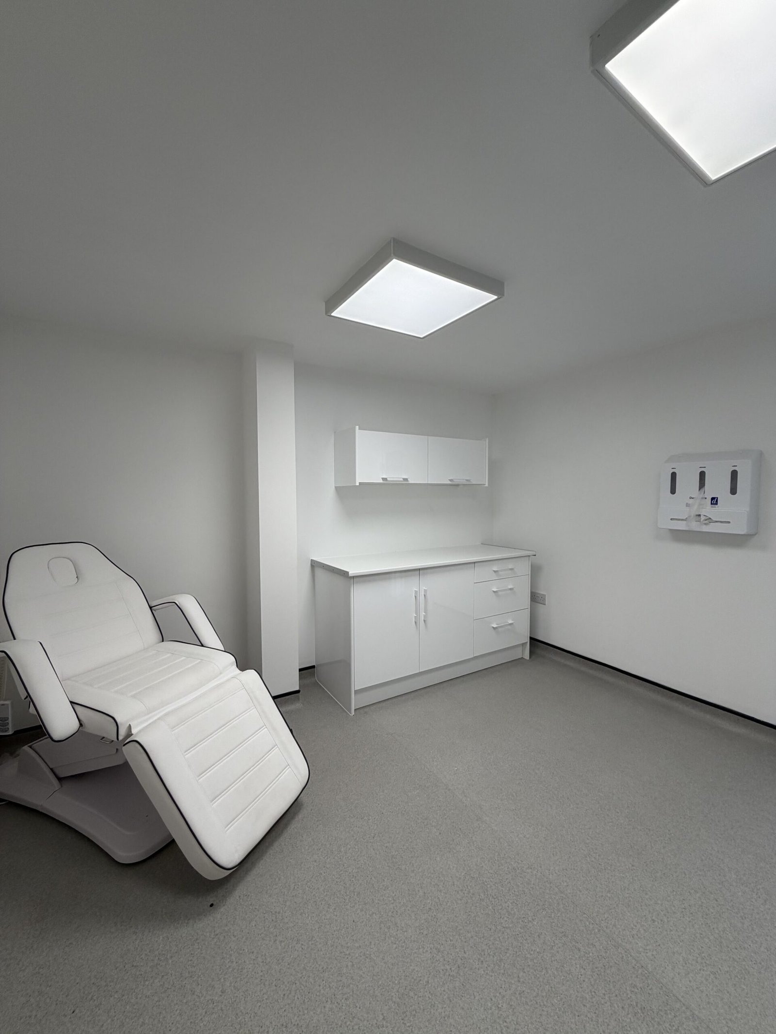 Bright, modern treatment room in the Wirral with adjustable bed 